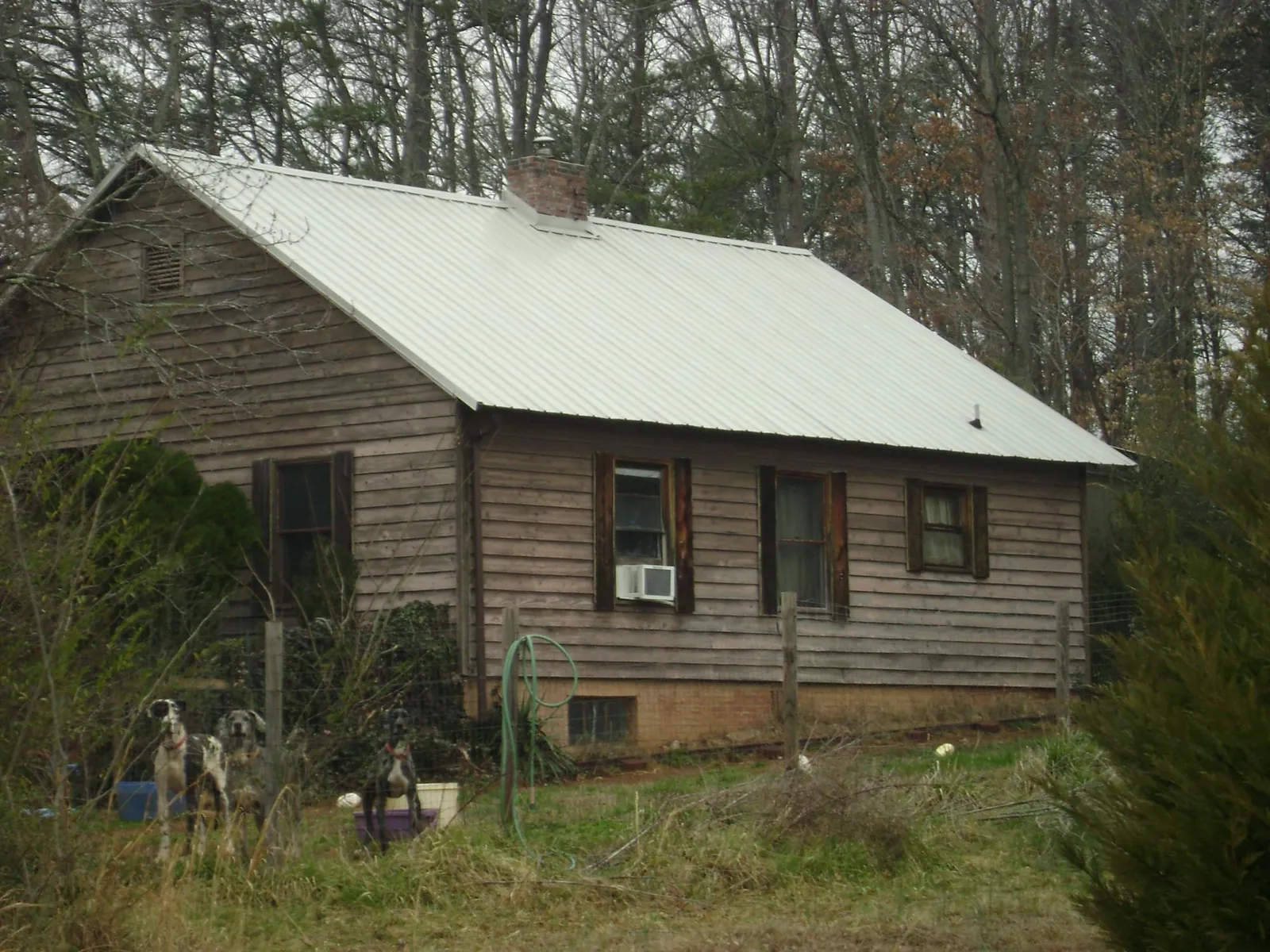 White metal roof on an old wood sided farmhouse, from a Metal Roof Installation job in Capon Bridge